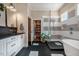 Modern bathroom featuring a glass-enclosed shower, soaking tub, and access to a walk-in closet at 2109 Meadowcreek Dr, Durham, NC 27705