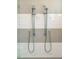 Modern shower with double shower heads, accented with white and grey tiles at 2109 Meadowcreek Dr, Durham, NC 27705