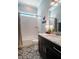Charming bathroom with patterned tile, a marble countertop, white subway tile in shower and garden window above at 2109 Meadowcreek Dr, Durham, NC 27705