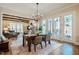 Bright dining room with a chandelier and large windows and doors leading to an outdoor space at 2109 Meadowcreek Dr, Durham, NC 27705