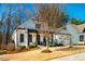 Charming two-story home with white siding, black trim, covered porch, and well-manicured landscaping at 2109 Meadowcreek Dr, Durham, NC 27705