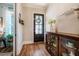 Inviting foyer with hardwood floors, decorative console table, and a stylish, patterned glass front door at 2109 Meadowcreek Dr, Durham, NC 27705