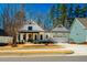 Inviting curb appeal showcasing a modern farmhouse with a two-car garage and manicured lawn at 2109 Meadowcreek Dr, Durham, NC 27705