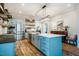 Bright kitchen features stainless steel appliances, a center island with storage, and light blue cabinetry at 2109 Meadowcreek Dr, Durham, NC 27705