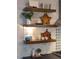 Beautiful kitchen featuring wood shelving with decorative items, stainless steel appliances, and a tile backsplash at 2109 Meadowcreek Dr, Durham, NC 27705