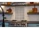 Beautiful kitchen features stainless steel appliances, a stylish backsplash, and open shelving at 2109 Meadowcreek Dr, Durham, NC 27705