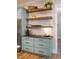 Kitchen nook includes stainless steel refrigerator and drawers beneath wooden shelving at 2109 Meadowcreek Dr, Durham, NC 27705