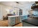 Modern kitchen island with stainless steel appliances and an open view to the dining and living area at 2109 Meadowcreek Dr, Durham, NC 27705