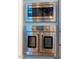 Close up on stainless steel oven and microwave in light blue kitchen cabinetry at 2109 Meadowcreek Dr, Durham, NC 27705
