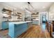 Stylish kitchen features a large center island, stainless appliances, open shelving and beautiful hardwood floors at 2109 Meadowcreek Dr, Durham, NC 27705