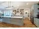 Charming kitchen features a large island, stainless steel appliances, open shelving and hardwood floors at 2109 Meadowcreek Dr, Durham, NC 27705