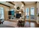 Inviting living room featuring a brick fireplace, built-in shelving, and backyard views at 2109 Meadowcreek Dr, Durham, NC 27705