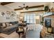 Cozy living room featuring a large sectional sofa, a brick fireplace, and exposed wooden beams at 2109 Meadowcreek Dr, Durham, NC 27705