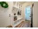 Inviting mudroom with built-in storage cubbies, bench seating, and easy access to the entryway and powder room at 2109 Meadowcreek Dr, Durham, NC 27705