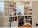 Well-organized pantry with custom shelving, mini fridge, and plenty of storage space at 2109 Meadowcreek Dr, Durham, NC 27705