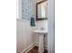 Chic powder room with blue and white wallpaper, pedestal sink, and modern fixtures at 2109 Meadowcreek Dr, Durham, NC 27705
