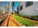 Landscaped side yard featuring lush ground cover and mature trees bordering a modern home at 2109 Meadowcreek Dr, Durham, NC 27705