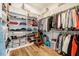 Spacious walk-in closet with custom shelving, wood flooring, and ample storage space for clothes and accessories at 2109 Meadowcreek Dr, Durham, NC 27705