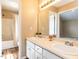 Bathroom with a double vanity, large mirror, wood floors and a separate room for the shower and toilet at 212 Walnut Creek Dr, Clayton, NC 27520