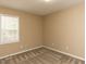 Neutral bedroom offers natural light from window and neutral carpet, ready for personalization at 212 Walnut Creek Dr, Clayton, NC 27520