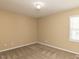 Bedroom with neutral paint, carpet, a window, and an overhead light fixture for illumination at 212 Walnut Creek Dr, Clayton, NC 27520
