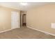 Bedroom with neutral paint, carpet flooring and access to a closet and another room at 212 Walnut Creek Dr, Clayton, NC 27520
