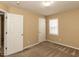 Well-lit bedroom with neutral carpet provides a comfortable space with natural light from the window at 212 Walnut Creek Dr, Clayton, NC 27520