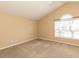 Neutral bedroom with light brown carpet, baseboard molding, and a window with blinds for plenty of natural light at 212 Walnut Creek Dr, Clayton, NC 27520