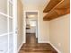 View of the foyer with coat rack, hardwood floors and a view into the kitchen with white appliances and cabinets at 212 Walnut Creek Dr, Clayton, NC 27520