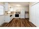 Well-lit kitchen featuring white cabinets, stainless steel appliances, and ample storage at 212 Walnut Creek Dr, Clayton, NC 27520
