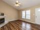Bright living room featuring wood-look flooring, fireplace, and a ceiling fan at 212 Walnut Creek Dr, Clayton, NC 27520
