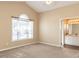 Spacious main bedroom with vaulted ceiling, a large window, carpeted floors and an attached bathroom with double sink vanity at 212 Walnut Creek Dr, Clayton, NC 27520