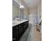 Neutral toned bathroom with double vanity, framed mirror, shower/tub and tiled floor at 2132 Royal Berry Ct, Cary, NC 27511
