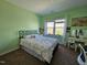 Bright bedroom with green walls, large window, and a full-sized bed with patterned comforter at 2132 Royal Berry Ct, Cary, NC 27511