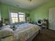 Bright bedroom featuring a bed, desk, and natural light from the large window at 2132 Royal Berry Ct, Cary, NC 27511