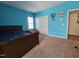 Bright bedroom featuring a bed, closet, and light blue walls at 2132 Royal Berry Ct, Cary, NC 27511
