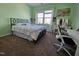 Bright bedroom featuring a bed, desk, and natural light from the large window at 2132 Royal Berry Ct, Cary, NC 27511