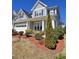 Charming two-story home with a manicured front yard, complemented by gray siding and black shutters at 2132 Royal Berry Ct, Cary, NC 27511