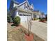 Charming two-story home with a two car garage, well-maintained landscaping, and a concrete driveway at 2132 Royal Berry Ct, Cary, NC 27511