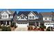 View of a two story home with solar panels on the roof, manicured landscaping, and an attached garage at 2132 Royal Berry Ct, Cary, NC 27511