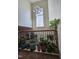 Bright foyer with tall windows, modern chandelier, and decorative plants lining the ledge at 2132 Royal Berry Ct, Cary, NC 27511
