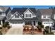 Charming two-story home with a well-manicured lawn, solar panels, and an attached garage at 2132 Royal Berry Ct, Cary, NC 27511
