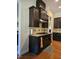 Beautiful kitchen featuring dark cabinetry, granite countertops, and tiled backsplash at 2132 Royal Berry Ct, Cary, NC 27511