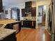 Kitchen features dark cabinetry, tile backsplash, stainless appliances, and hardwood flooring at 2132 Royal Berry Ct, Cary, NC 27511