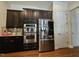 Kitchen showcasing stainless steel appliances and dark wood cabinetry with ample storage at 2132 Royal Berry Ct, Cary, NC 27511