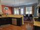Open kitchen features granite countertops, dark cabinets, stainless appliances, and hardwood flooring at 2132 Royal Berry Ct, Cary, NC 27511
