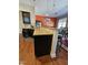 Kitchen featuring granite counters, dark cabinets, breakfast bar with seating and wood floors at 2132 Royal Berry Ct, Cary, NC 27511