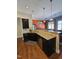 Kitchen with granite countertops, dark cabinets, stainless appliances, hardwood floors, and adjacent dining area at 2132 Royal Berry Ct, Cary, NC 27511