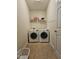 Functional laundry room with side-by-side washer and dryer and shelving for storage at 2132 Royal Berry Ct, Cary, NC 27511