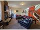 Cozy living room with a stone fireplace and comfortable leather furniture at 2132 Royal Berry Ct, Cary, NC 27511